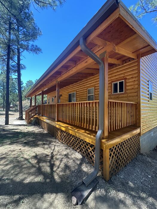 Log cabin garage and siding after professional exterior staining