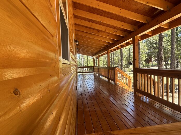 Log cabin covered deck after exterior stain refresh near Vancouver WA