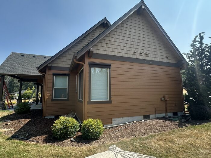 Craftsman home exterior near carport after full repaint