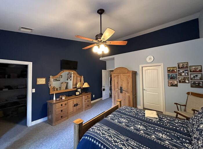 Bedroom interior repaint with navy blue accent wall, clean crisp lines