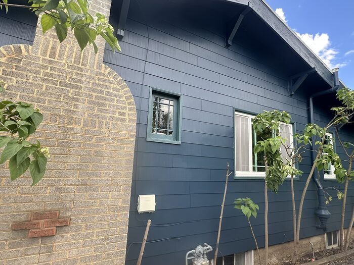 Close-up of navy exterior paint job showing clean trim lines and window detail