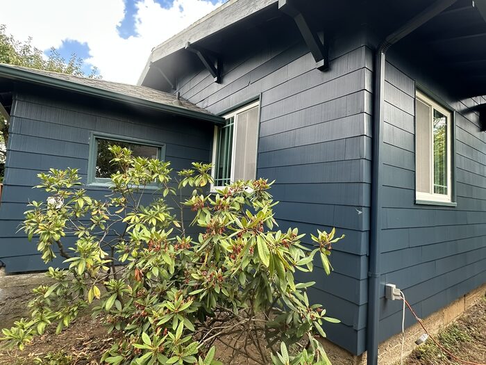 House exterior after full repaint in rich navy blue with white trim, Clark County WA