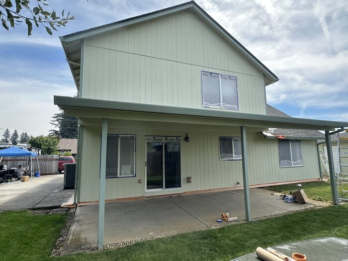 Exterior paint application in progress, spray and back-roll technique, Clark County WA
